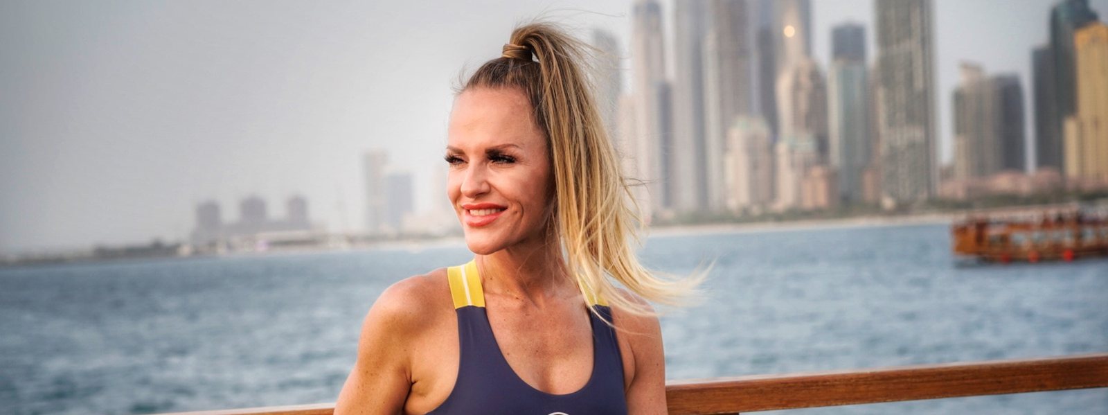 Dany Dobner smiling by the water, bright and relaxed