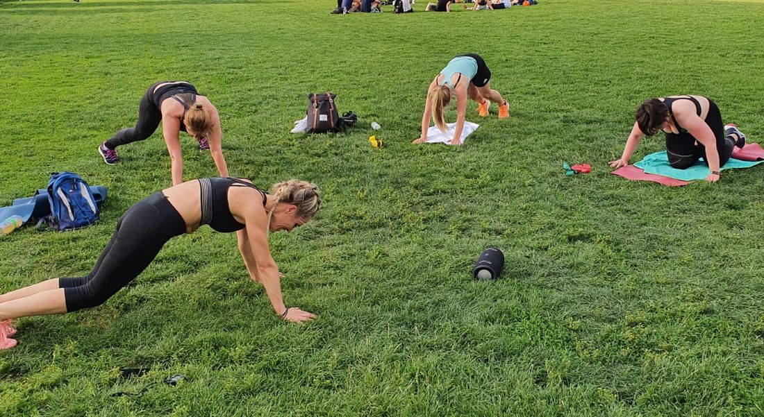 Dany Dobner leading an outdoor group workout in the park